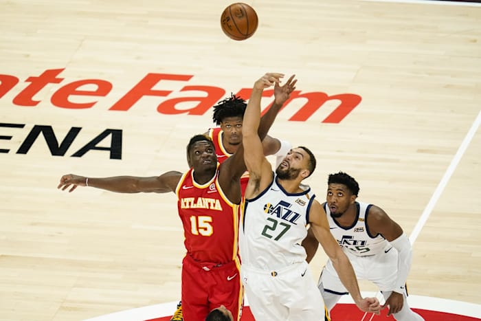 Rudy Gobert (27) and Clint Capela (15) compete for the opening tip.